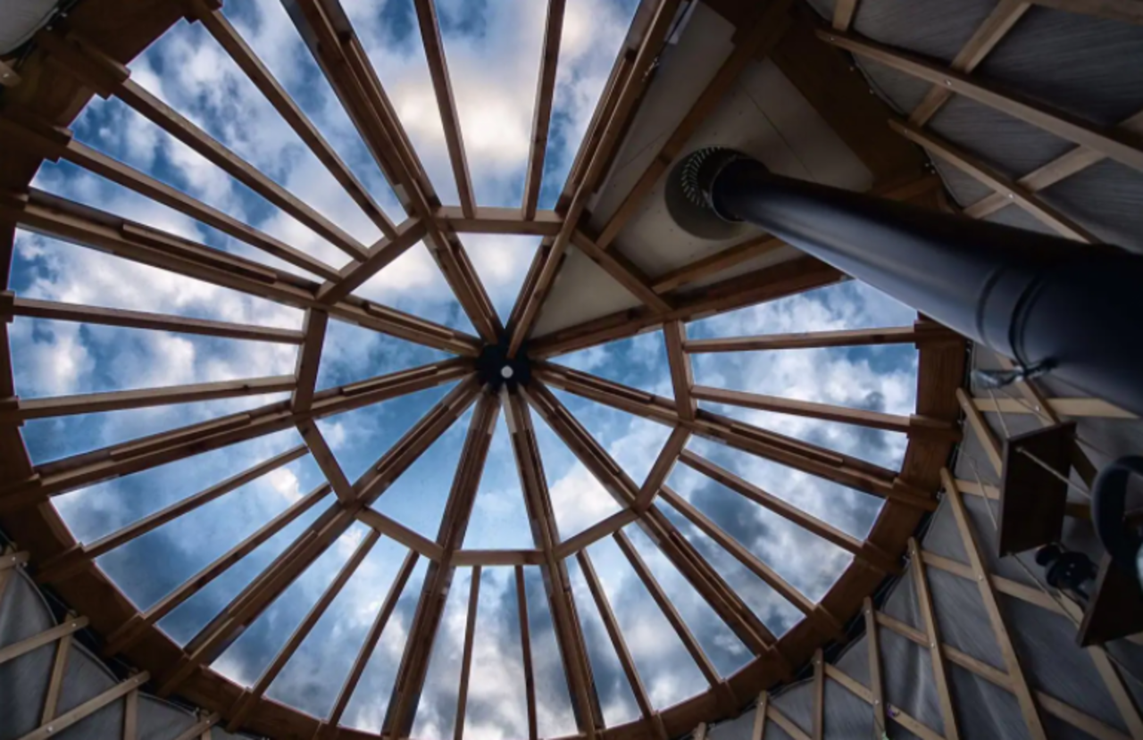 glass ceiling in yurt with blue sky